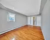 Unfurnished bedroom featuring light wood finished floors, visible vents, a baseboard heating unit, baseboards, and recessed lighting