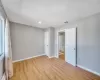 Empty room featuring light wood finished floors, visible vents, baseboards, recessed lighting, and a baseboard radiator