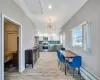 Dining space featuring recessed lighting, light wood-style floors, a baseboard radiator, baseboards, and attic access