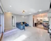 Living area with baseboards, visible vents, baseboard heating, and a chandelier