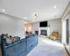 Living room featuring a baseboard heating unit, recessed lighting, and baseboards