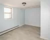 Spare room featuring baseboard heating and baseboards