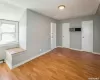 Additional living space with light wood-type flooring and baseboards