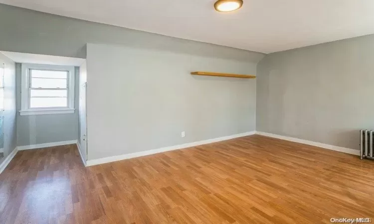 Empty room featuring baseboards and light wood finished floors