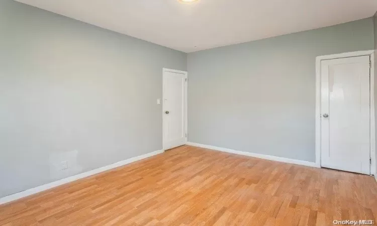 Unfurnished room with baseboards and light wood-style floors