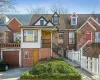 Townhome / multi-family property featuring aphalt driveway, an attached garage, fence, and brick siding