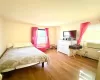 Bedroom featuring baseboard heating and light wood-style flooring