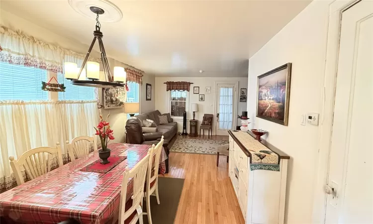 Dining room with a notable chandelier and light wood finished floors