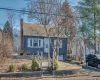 View of front of home featuring a chimney