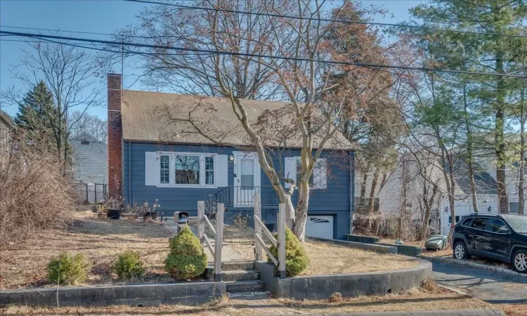 View of front of home featuring a chimney