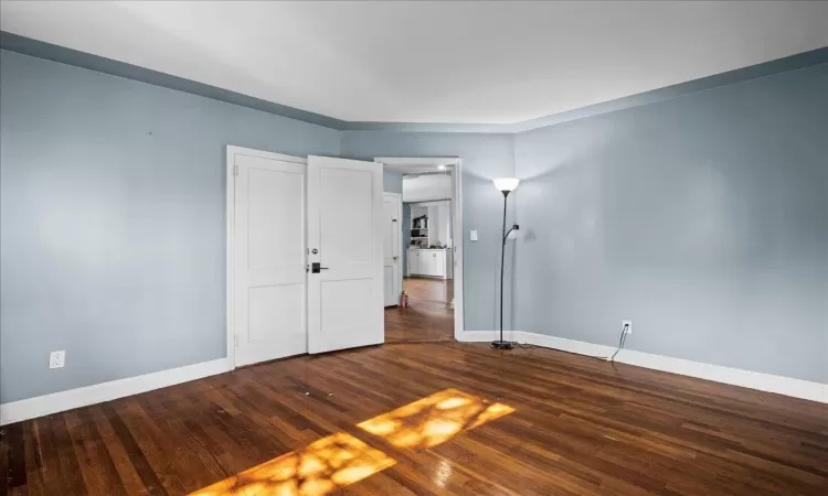 Empty room featuring baseboards and wood finished floors