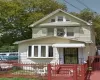 View of front of home featuring fence