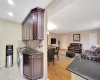 Kitchen featuring a sink, tasteful backsplash, dark countertops, open floor plan, and washer / dryer