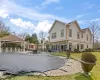 Rear view of property with fence, a gazebo, stucco siding, a yard, and a patio