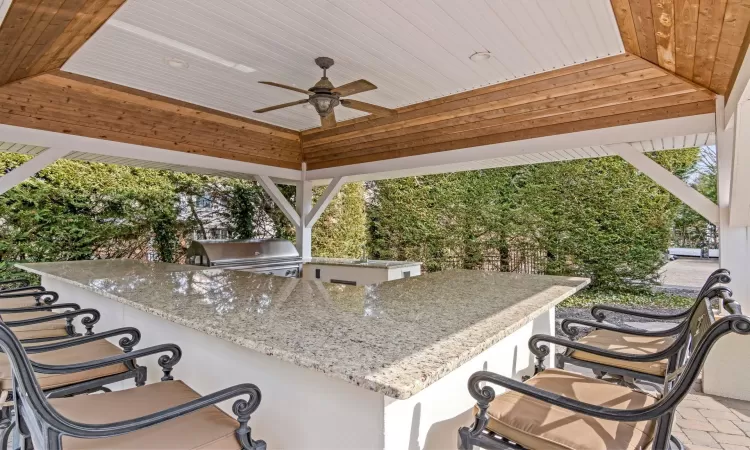 View of patio with ceiling fan, a gazebo, Viking grill, outdoor wet bar, and an outdoor kitchen