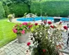 Outdoor saltwater heated pool featuring a patio and a yard