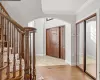 Entrance foyer featuring visible vents, baseboards, arched walkways, ornamental molding, and parquet floors