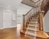 Stairway with visible vents, crown molding, baseboards, recessed lighting, and wood finished floors