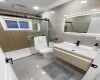 Full bathroom featuring toilet, tasteful backsplash, tile walls, a shower stall, and vanity