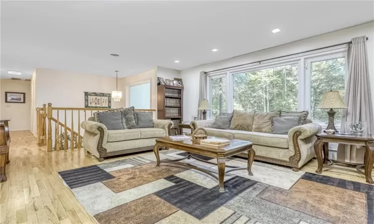 Living room with recessed lighting and light wood-style floors