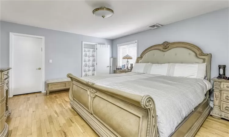 Bedroom with visible vents and light wood finished floors