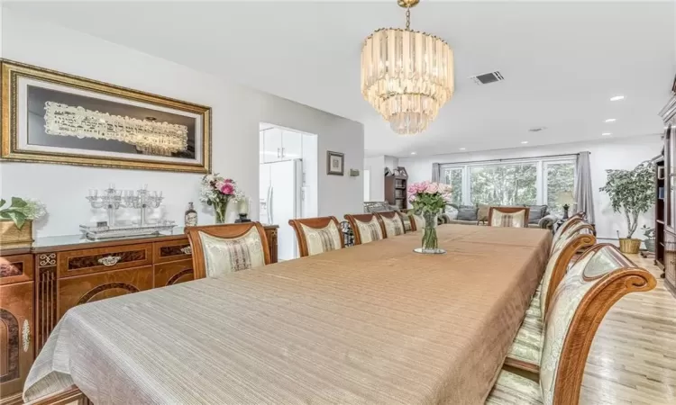 Dining space featuring recessed lighting, visible vents, a notable chandelier, and wood finished floors