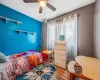 Bedroom with wood finished floors and a ceiling fan