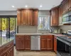 Kitchen with light wood-type flooring, a sink, recessed lighting, appliances with stainless steel finishes, and a toaster