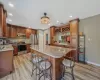 Kitchen with a center island, recessed lighting, light wood-style flooring, a kitchen breakfast bar, and stainless steel appliances