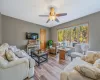 Living room with ceiling fan and light wood-style floors