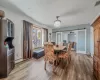 Dining space featuring visible vents, light wood-style flooring, baseboard heating, and a barn door