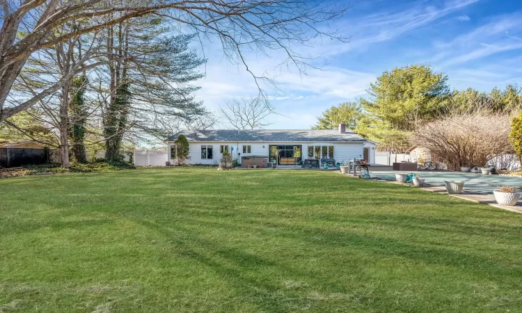 Ranch-style house featuring a swimming pool, fence, a front yard, a chimney, and a patio area