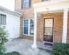 Doorway to property featuring brick siding