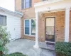 View of exterior entry featuring brick siding