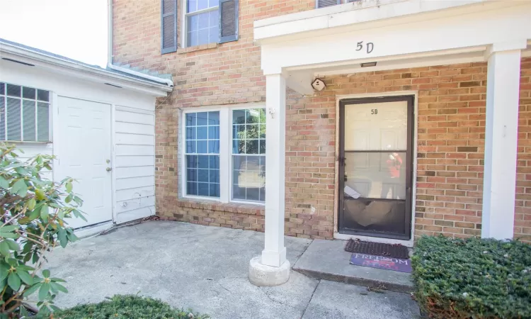 View of exterior entry featuring brick siding