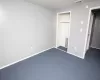 Unfurnished bedroom with a closet, visible vents, baseboards, and dark colored carpet