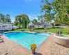 View of swimming pool with a patio, a fenced in pool, a fenced backyard, a jacuzzi, and a lawn