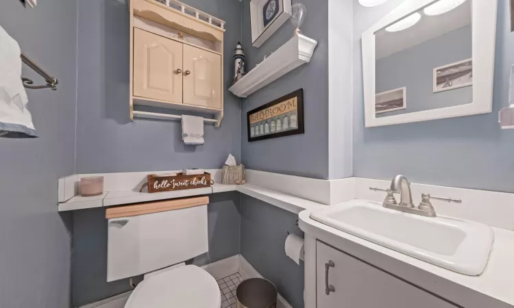 Half bathroom featuring toilet and vanity