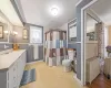 Bathroom with vanity, a shower with shower curtain, radiator heating unit, crown molding, and toilet