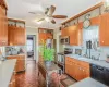 Kitchen with a sink, light countertops, ornamental molding, appliances with stainless steel finishes, and open shelves