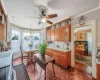 Kitchen featuring a sink, crown molding, light countertops, brown cabinetry, and range