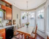 Dining area with brick floor, a chandelier, radiator heating unit, and crown molding