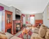 Living room featuring visible vents, crown molding, and wood finished floors