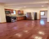 Kitchen featuring lofted ceiling, dark hardwood / wood-style floors, tasteful backsplash, stainless steel appliances, and a baseboard radiator