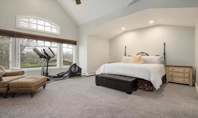 Carpeted bedroom with baseboard heating, recessed lighting, high vaulted ceiling, and a ceiling fan