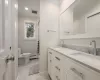 Full bath with a sink, visible vents, toilet, and crown molding