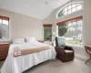 Bedroom featuring carpet flooring, lofted ceiling, and multiple windows