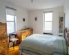 Bedroom featuring multiple windows and wood finished floors