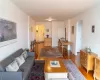 Living area featuring baseboards, arched walkways, and wood finished floors