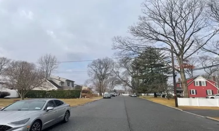 View of street with a residential view and curbs